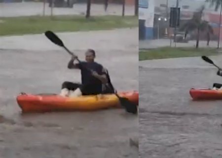Com ruas submersas após temporal, morador apela para travessia com caiaque em Nova Andradina